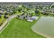 Community aerial view with a pool, clubhouse, and lake, creating a resort-like atmosphere at 17357 Austrian Pine Way, Westfield, IN 46074