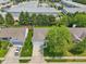 An aerial view of the house in a neighborhood showcasing the roof and front lawn, and large commercial buildings nearby at 17357 Austrian Pine Way, Westfield, IN 46074