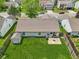 Aerial view of a fenced backyard with a well-maintained lawn, a storage shed, patio, and a fire pit at 17357 Austrian Pine Way, Westfield, IN 46074