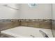 A bathtub with tile surround offers a place to relax and unwind at 17357 Austrian Pine Way, Westfield, IN 46074