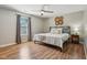 Bedroom boasts wood floors, a large window, and a neutral-colored ceiling fan at 17357 Austrian Pine Way, Westfield, IN 46074