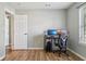 Bedroom features a hardwood floor, a desk with dual monitors, and a window at 17357 Austrian Pine Way, Westfield, IN 46074