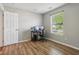 Bedroom features a hardwood floor, a desk with dual monitors, and a window at 17357 Austrian Pine Way, Westfield, IN 46074