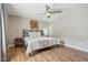 Bedroom with wood floors, a large window, and a neutral-colored ceiling fan at 17357 Austrian Pine Way, Westfield, IN 46074