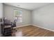 Bright bedroom with a hardwood floor, a chair, and a desk next to a window at 17357 Austrian Pine Way, Westfield, IN 46074