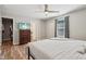 Bedroom showcases wood floors, a dresser with a TV, and access to the bathroom at 17357 Austrian Pine Way, Westfield, IN 46074