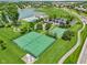 Aerial view of tennis courts and pool area, and a community lake at 17357 Austrian Pine Way, Westfield, IN 46074