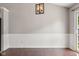 Bright dining room area featuring neutral paint, wood floors, and a modern light fixture at 17357 Austrian Pine Way, Westfield, IN 46074