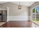 Dining room area featuring stylish lighting, wood floors and wainscoting details at 17357 Austrian Pine Way, Westfield, IN 46074