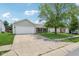 Pictured home with a wide driveway, manicured lawn, and mature trees at 17357 Austrian Pine Way, Westfield, IN 46074