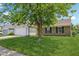 Well-maintained home with a large front yard, driveway, and mature tree at 17357 Austrian Pine Way, Westfield, IN 46074