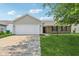 Features a single-story home with brick accents, well maintained yard, and wide driveway at 17357 Austrian Pine Way, Westfield, IN 46074
