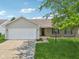Charming home has a two-car garage, brick facade, and a beautifully manicured lawn at 17357 Austrian Pine Way, Westfield, IN 46074