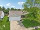 Aerial view showcasing the home's front exterior with an attached two-car garage and a lush green lawn at 17357 Austrian Pine Way, Westfield, IN 46074