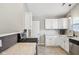 Bright kitchen with white cabinets, granite countertops, and a stainless steel dishwasher at 17357 Austrian Pine Way, Westfield, IN 46074