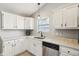 Well-lit kitchen showcases white cabinets, stainless steel dishwasher, and granite countertops at 17357 Austrian Pine Way, Westfield, IN 46074
