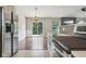 Well-lit kitchen and dining area features stainless steel appliances and sliding glass doors to the backyard at 17357 Austrian Pine Way, Westfield, IN 46074