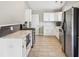 Bright kitchen featuring white cabinets, stone countertops, and stainless steel appliances at 17357 Austrian Pine Way, Westfield, IN 46074