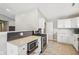 Bright kitchen features white cabinetry, stainless steel appliances, and a stylish tile backsplash at 17357 Austrian Pine Way, Westfield, IN 46074