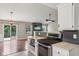 Open-concept kitchen with stainless steel appliances and an expansive view into the living area at 17357 Austrian Pine Way, Westfield, IN 46074