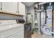 Functional laundry room with modern washer and dryer, storage cabinets and utility equipment at 17357 Austrian Pine Way, Westfield, IN 46074