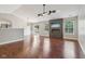 Spacious living room features hardwood floors, a ceiling fan, and a modern fireplace with mounted television at 17357 Austrian Pine Way, Westfield, IN 46074