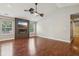 Open living room featuring hardwood floors, vaulted ceilings, a ceiling fan, and modern fireplace with mounted television at 17357 Austrian Pine Way, Westfield, IN 46074
