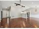 Spacious living room with hardwood floors and an open floor plan, showcasing the front door and kitchen at 17357 Austrian Pine Way, Westfield, IN 46074