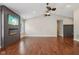 Living room features hardwood floors, vaulted ceilings, a ceiling fan, and a modern fireplace with mounted television at 17357 Austrian Pine Way, Westfield, IN 46074