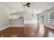 Spacious living room with hardwood floors and an open floor plan that flows to an outdoor patio and kitchen at 17357 Austrian Pine Way, Westfield, IN 46074