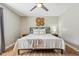 Comfortable main bedroom with textured accent wall, ceiling fan, and stylish decor at 17357 Austrian Pine Way, Westfield, IN 46074
