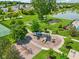Aerial view of a community playground that features slides, swings, and a lovely lake view at 17357 Austrian Pine Way, Westfield, IN 46074