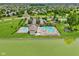 Aerial shot of a community pool area, showcasing the pool and lounging space by the lake at 17357 Austrian Pine Way, Westfield, IN 46074