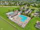 Aerial view of a community pool area with ample seating, set by a serene lake at 17357 Austrian Pine Way, Westfield, IN 46074