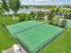Aerial view of well-maintained tennis courts in a community with a lake and clubhouse at 17357 Austrian Pine Way, Westfield, IN 46074