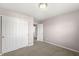 Bedroom with neutral walls and carpet, featuring a closet and a connecting door at 1829 Archbury Dr, Avon, IN 46123