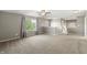 Spacious bonus room features neutral carpet, a ceiling fan, and a bright window view at 1829 Archbury Dr, Avon, IN 46123