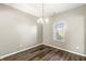 Bright dining room with hardwood floors, a chandelier, and a window providing natural light at 1829 Archbury Dr, Avon, IN 46123