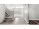 Inviting entryway showcasing tile flooring transitioning to carpet, with stairs leading to the upper level at 1829 Archbury Dr, Avon, IN 46123
