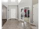 Welcoming foyer with tile flooring, a coat closet, and a view into an office with glass doors at 1829 Archbury Dr, Avon, IN 46123