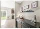 Hallway with a display table leading to the kitchen with dark wood cabinets and stainless steel appliances at 1829 Archbury Dr, Avon, IN 46123