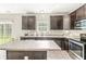 Spacious kitchen features dark cabinetry, stainless steel appliances, and granite countertops at 1829 Archbury Dr, Avon, IN 46123
