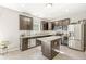 Modern kitchen with dark cabinetry, stainless steel appliances, and a center island with countertop seating at 1829 Archbury Dr, Avon, IN 46123