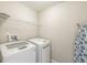 Convenient laundry room with washer, dryer, and wire shelving at 1829 Archbury Dr, Avon, IN 46123