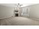 Comfortable living room features a fireplace, ceiling fan, and a view to the front yard at 1829 Archbury Dr, Avon, IN 46123