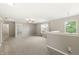 The upstairs loft with great natural light has carpeted floors and neutral paint at 1829 Archbury Dr, Avon, IN 46123