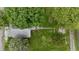 An aerial view of the home and lawn surrounded by lush trees and landscaping at 204 S Conger St, Saint Paul, IN 47272