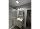 Bright bathroom featuring a vanity with storage and a glass-enclosed shower at 204 S Conger St, Saint Paul, IN 47272