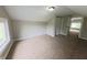 A bedroom featuring neutral walls, carpeting, a closet, and a window at 204 S Conger St, Saint Paul, IN 47272