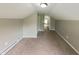 A bedroom with neutral walls, carpeting, a closet, and a staircase at 204 S Conger St, Saint Paul, IN 47272